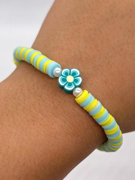 Handmade 7 in. preppy beaded bracelet. Contains light blue and yellow 6mm clay beads. Also has pearl beads, and a cute flower bead!! I can custom create any jewelry for you. Just let me know what colors you want, and if you want a word on it or not. I can also make phone charms and rings, and necklaces. Preppy Bracelet Ideas Clay Beads Blue Pink Yellow, Blue Bracelets Clay Beads, Light Blue Clay Bead Bracelet, Coconut Girl Bracelets Clay Beads, Blue And Yellow Clay Bead Bracelet, Bracelets Preppy, Beige Bracelet, Make Clay Beads, Colorful Bead Bracelets