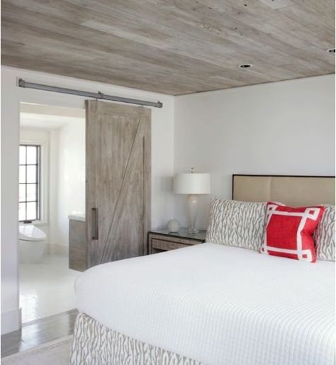 A modern version of the look is seen in this Florida bedroom. Keeping the ceiling, barn door, and bathroom vanity the same material creates flow and serenity, while the rustic wood itself is a cool feature. Florida Bedroom, House Ceiling Design, Basement Apartment, Basement Ceiling, Basement Bedrooms, Coastal Bedrooms, Coastal Bedroom, Basement Renovations, Wood Ceilings