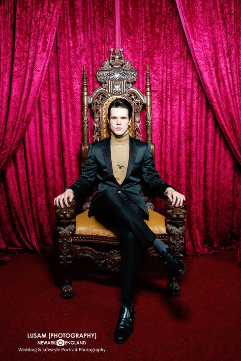 male model in black suit on throne. Cool, moody and sultry. Studio Photoshoot Man Sitting On Throne, King Sitting On Throne Pose, Vampire Photoshoot Male, Men Suit Photoshoot Studio, Male Model Studio Photoshoot, Sitting Pose Reference, Chair Pose, Black Male Models, Male Models Poses