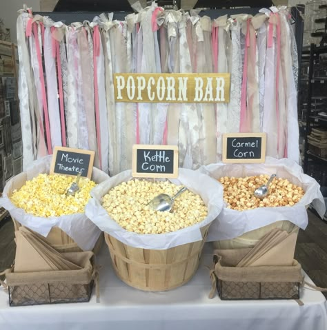 Popcorn bar with bushel baskets and fabric garland backdrop