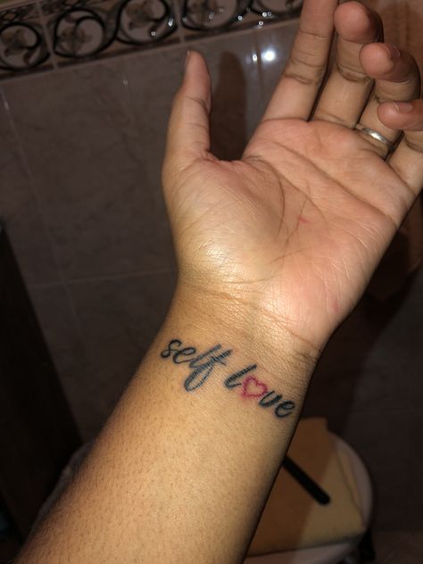 Self Love Wrist Tattoo Self Love Hand Tattoo, Love Yourself Tattoos For Black Women, Red Ink Wrist Tattoo, Baddie Wrist Tattoos, Self Love Wrist Tattoo, Tattoo Ideas Black Women Self Love, Wrist Tattoos For Black Women, Wrist Tattoo Black Women, Little Wrist Tattoos For Women