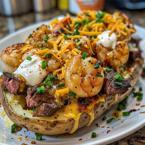 🥔 Steak & Shrimp Loaded Baked Potato: Hearty and luxurious, loaded with juicy steak and shrimp! #LoadedPotatoLuxury Steak & Shrimp Loaded Baked Potato Ingredients: Large potatoes (4) Steak, cubed (1 lb (450 g)) Shrimp, peeled (1/2 lb (225 g)) Butter (4 tbsp (60 g)) Sour cream (1/2 cup (120 ml)) Cheddar cheese, shredded (1 cup (100 g)) Chives, chopped (1/4 cup (25 g)) Instructions: Bake potatoes until tender. Sauté steak and shrimp. Split potatoes, fill with steak, shrimp, butter, sour cre... Steak Bite Baked Potatoes, Steak And Shrimp Stuffed Potatoes, Surf And Turf Loaded Baked Potato, Shrimp Alfredo Baked Potato, Steak And Shrimp Stuffed Bread, Chicken And Shrimp Baked Potato, Steak And Shrimp Loaded Baked Potato, Loaded Baked Potato With Shrimp, Shrimp And Potatoes Recipes