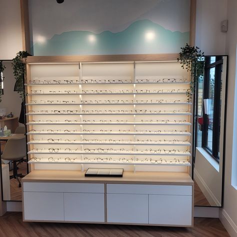 Light wood grain cabinets with white accents, perfect for eyeglass display. Illuminated by LED lights. #OptometryClinic #Optometry #EyewearShowcase #LEDLighting #InteriorDesign Wood Grain Cabinets, Eyeglass Display, Show Case, White Accents, Light Wood, Wood Grain, Grain, Led Lights, Portfolio