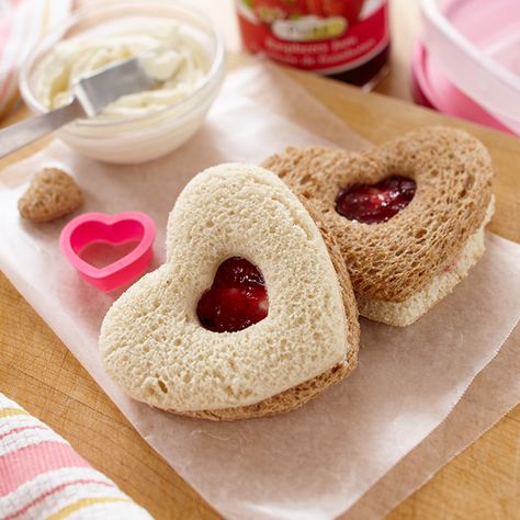 These heart-shaped sandwiches are a fun addition to your child s Valentine s Day lunchbox. Smucker s® Pure Raspberry Jam and cream cheese can be seen through a peak-a-boo heart-shaped window on top. Shaped Sandwiches, Kid Sandwiches, Kids Birthday Party Food, Valentines Snacks, Healthy Valentines, Mini Sandwiches, Finger Sandwiches, Valentines Day Food, Kids Party Food