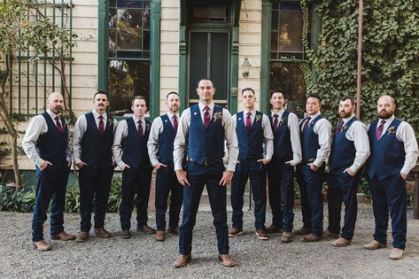 groom and groomsmen in navy slacks and vest look Groom Vest No Jacket, Navy Jacket With Jeans Wedding Men, Groomsmen In Jeans And Vests, Navy Blue Vest Groomsmen With Jeans, Navy Blue Vest Groomsmen, Groomsmen Vest Attire, Navy Vest Groomsmen, Vest Groomsmen Attire, Groomsmen Attire No Jacket