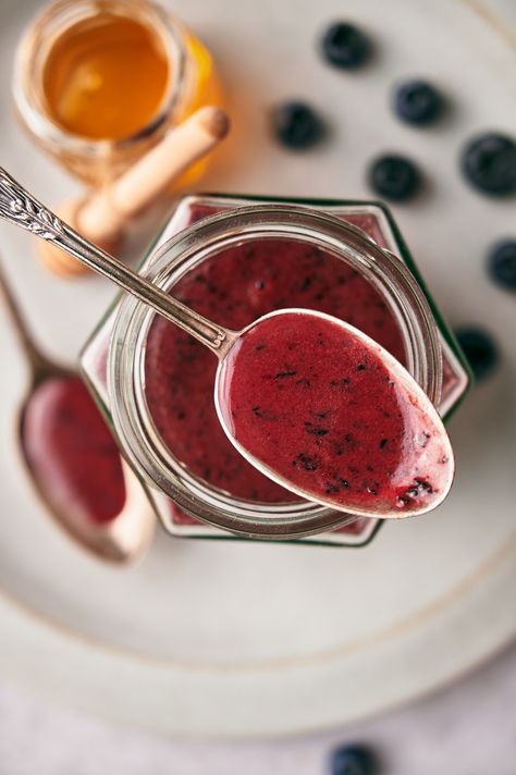 Blueberry vinaigrette salad dressing on a spoon over a glass jar with blueberries and a jar of honey blurred in the background. Blueberry Vinaigrette, Healthy Blueberry, Lemon Vinaigrette, Dinner Guests, Vinaigrette Dressing, Dinner Guest, Honey Lemon, Lemon Blueberry, Green Kitchen