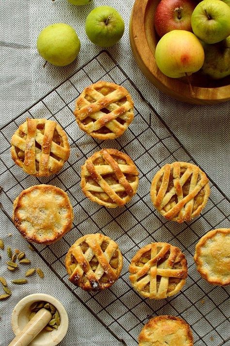 Mini apple hand pies baked in a muffin tin spiced with cardamom and cinnamon Hand Pies Baked, Mini Apple Tarts, Apple Cardamom, Mini Apple Pie Recipe, Cinnamon Roll Apple Pie, Tin Recipes, Apple Pie Bites, Apple Pie Bars, Apple Hand Pies