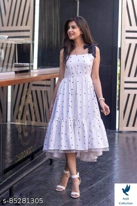 White Polka Print Full Flared Dress Name: White Polka Print Full Flared Dress Fabric: Crepe Sleeve Length: Sleeveless Pattern: Printed Net Quantity (N): 1 Sizes: S (Bust Size: 34 in, Length Size: 44 in) M (Bust Size: 36 in, Length Size: 44 in) L (Bust Size: 38 in, Length Size: 44 in) XL (Bust Size: 40 in, Length Size: 44 in) XXL (Bust Size: 42 in, Length Size: 44 in) A beautiful polka print full flared white dress has a round neck contrast shoulder straps in bow design ruffled flared Cute Long Frocks, Western Dress Poses For Women, Simple White Frock Design, Poses In Long Dresses, Cute Frocks For Women, White Frocks For Women, Long Dress Poses, Polka Dot Long Dress, Shaurya Sanadhya