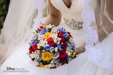 A colorful bridal bouquet pops against a gorgeous white wedding dress Disney Bouquet Wedding, Snow White Wedding Theme, Flowers Bouquet Ideas, Dawn Wedding, Snow White Wedding, Colorful Bridal Bouquet, Disney World Wedding, Disney Inspired Wedding, Disney Weddings