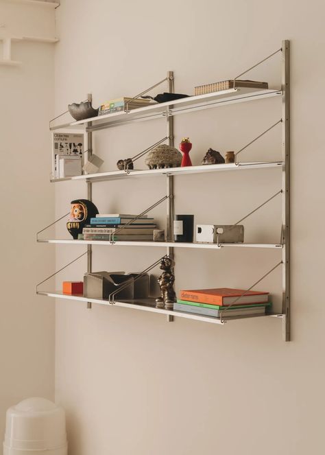 Chrome Design: 6 Design Tips and Mindset Shifts That Don’t Feel Sterile | Architectural Digest Ligne Roset Sofa, Wall Bookshelf, Chrome Design, Bag Rack, Wall Bookshelves, Grey Dining, Wall Rack, Steel Shelf, Wall Racks