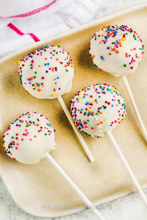 For a fun party activity, try making this easy cake pop recipe with the kids. It's simple to make with cake mix and a jar of frosting, but homemade ingredients from scratch can be used too! When it comes to decorations, the kids will have a great time coming up with their own sweet creations. #easycakepoprecipe #cakepopsrecipe #easybirthdaycakepops #theshortcutkitchen Cake Pops No Frosting, Cake Pops From Box Cake, Cake Pop Recipe With Cream Cheese, Cake Pops With Cake Mix Boxes, Cake Pop Recipe With Box Cake, Cake Pops With Frosting, Pop Cakes Recipe, Easy Cake Pops 3 Ingredients, Cake Pops Without Frosting