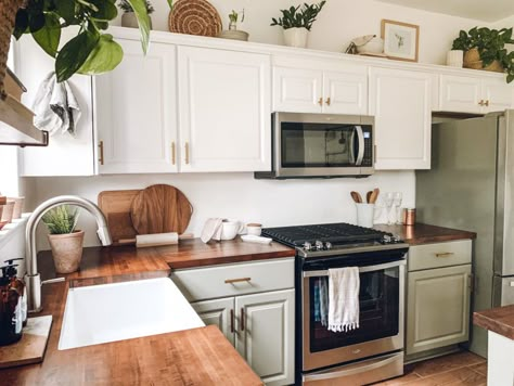 Green And White Kitchen Cabinets Butcher Block, White Cabinet Boho Kitchen, Olive Green And White Kitchen Cabinets, Plants Over Cabinets, Low Cabinets In Kitchen, White And Butcher Block Kitchen, Off White And Green Kitchen Cabinets, Sage Bottom Cabinets White Top, Green Lower Cabinets White Upper Butcher Block