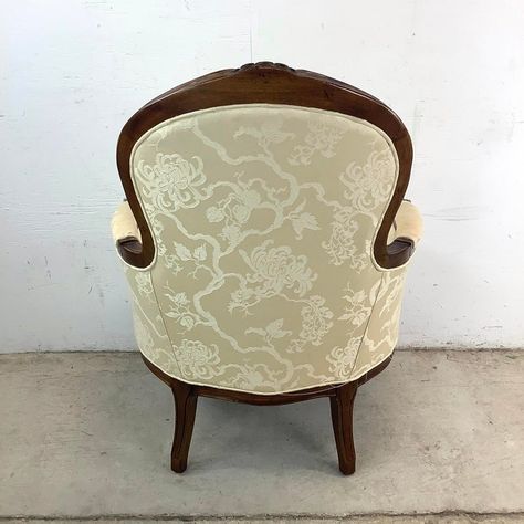 Timeless elegance meets refined craftsmanship in this Vintage Louis XV Style Bergère Armchair by Bernhardt Furniture. With its graceful silhouette and classic French design, this chair captures the opulence and charm of the Louis XV period while offering the comfort and quality expected from Bernhardt. The beautifully carved wooden frame showcases delicate detailing, from its cabriole legs to the subtly curved arms, all finished with a warm patina that enhances its antique character.  This Bergère armchair invites relaxation with its deep, plush cushioning and upholstered seat and backrest. The generous proportions and flowing lines make it a welcoming piece, perfect for lounging in style. The upholstery is both elegant and versatile, complementing the rich woodwork with a soft, luxurious