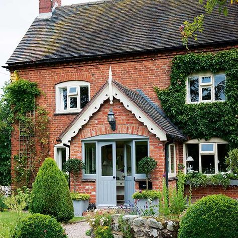 red brick farmhouse with large central porch, white coving and light blue front door Cottage Hardscaping, Edwardian Exterior, Chalet Extension, Cottage Cake, Stone Porch, Cottage Extension, Brick Cottage, English Cottage Decor, Cottage Porch