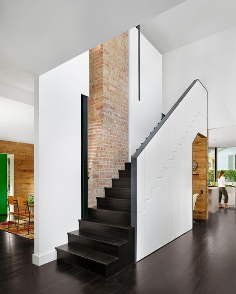 The exposed brick chimney features prominently in the stairwell space. The modern stairwell design adds visual interest in a space that might otherwise seem lackluster. Contemporary Staircase, Brick Chimney, Escalier Design, Wood Stairs, Interior Stairs, Modern Staircase, Stair Storage, Storage Design, Loft Spaces