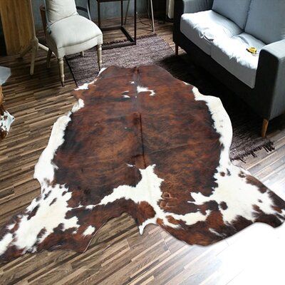 Add a rustic charm to your interior design with this beautifully crafted cowhide featuring an all-natural pattern with shades of brown white and black. Their cowhides are fully organic and are non-colour-treated as well as non-salt-treated which makes the longevity and shine of these cowhides last longer. These elegant cowhides are made of the highest quality which will easily complement any indoor living space with their rustic yet modern feel. They are naturally tanned and crafted to last with Whiskey Den, Cowhide Rug Decor, Southwestern Bedroom, Apartment Necessities, Farm Room, Cow Rug, Record Room, Hide Rugs, Sisal Area Rugs