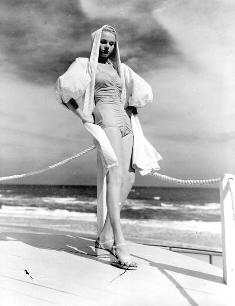 When cold weather blows into Florida, for those very few days, dress warmly with this coat and hood. (1947) | Florida Memory Pin Up Swimsuit, Classic Actresses, Miami Fashion, Blonde Bombshell, 1940s Fashion, Golden Age Of Hollywood, Vintage Pinup, Pin Up, Fashion Show