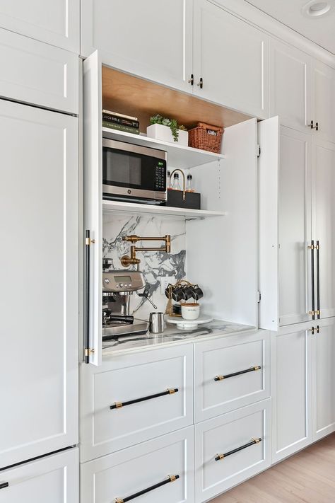 A wall of built-in cabinets is the perfect place to add a coffee/espresso station. The cabinet has pocket doors that slide into place so the cabinet can remain open during use. High end finishes include a porcelain countertop and backsplash and a luxe gold Brizo pot filler faucet. Hidden Coffee Bar, Woodland Cabinetry, Home Coffee Stations, Coffee Bars In Kitchen, Balance Design, Dream Kitchens, Kitchen Inspiration Design, Built In Cabinets, Pantry Design