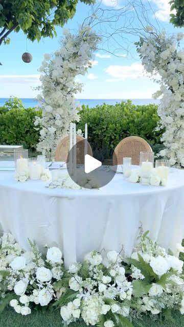 Designs by Hemingway on Instagram: "ALL WHITE WEDDING FLORALS / our modern open air arch made another appearance this weekend ! The wedding ceremony set up commenced on the ocean lawn  @fsoahu & all florals were reset at the reception framing the couples table. Congratulations Raquel & Armand ! Another beautiful  day in paradise ! Island of Oahu ! #dbhemingway 
🌸

Florals / styling/ design @dbhemingway 
Structure rental @hemingwayfineartstudio 
Venue @fsoahuevents 
Chairs / linens / lighting @pacificpartyrentals 
Coordinator  @forthegoodevents 
Photography @keanibakula 
Hmua @revealhairandmakeup 
Officiant @marry_me_hawaii 
.
.
.
.
.
#hawaiiarchrentals #oahuceremony #oahuceremonybackdrop #oahuceremonyarchrental #hawaiiwedding #hawaiiwhitewedding #fourseasonsoahuwedding #fourseasonsoahucer Couples Table, White Wedding Florals, All White Wedding, Oahu Wedding, On The Ocean, Ceremony Arch, Ceremony Backdrop, Paradise Island, Wedding Florals