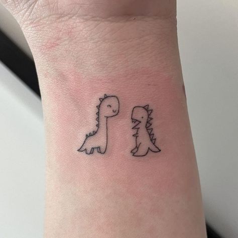 Small Cartoon Dinosaur Tattoo, Dinosaur Friend Tattoo, Line Work Dinosaur Tattoo, Trex Cute Tattoo, Cute Trex Tattoo Ideas, Cute Dinosaur Tattoo Ideas, Dinosaur Small Tattoo, Mom And Son Dinosaur Tattoo, Cute Dino Tattoo Ideas