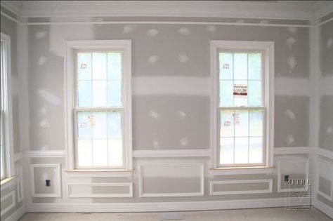 This shows a Living room with a 5 piece crown moulding, 2 piece chair rail, panel moulding shadowboxes, 5" baseboard, and windows with a 3.5" Adams casing. Wainscoting Height, Wainscoting Nursery, Wainscoting Hallway, Wainscoting Stairs, Wainscoting Kitchen, Wood Wainscoting, Painted Wainscoting, Wainscoting Bedroom, Wainscoting Bathroom