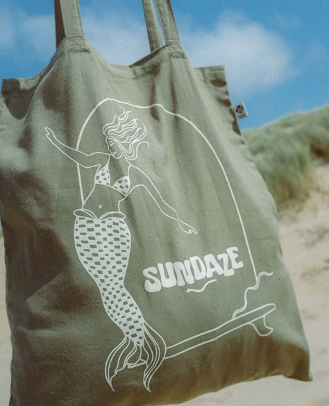 The new organic cotton Mermaid Tote for all you beautiful mermaids out there! 🧜‍♀️⁠ ⁠ Swipe for some BTS of how 99% of our shoots go 🤣⁠ ⁠ ⁠ ⁠ ⁠ ⁠ ⁠ ⁠ ⁠ #sundazesurf #mermaidtote #sustainablebrand #organiccotton #bts Surf Swimwear, Mermaid Magic, Sunset Session, Everyday Tote Bag, Beautiful Mermaids, Everyday Tote, Retro Designs, Surf Wear, Sustainable Brand