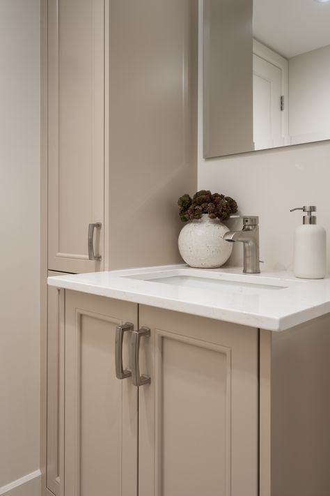 A neutral vanity with soft-toned cabinetry, modern fixtures, and simple decor, including a ceramic vase with textured plants. The design creates a calm and elegant bathroom space. Neutral Vanity, Modern Fixtures, Neutral Bathroom, Natural Decor, Of Montreal, Service Projects, English House, Finishing Basement, Construction Company