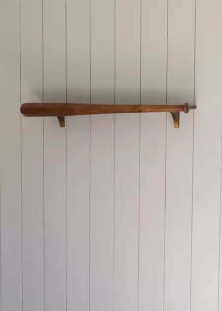 The baseball bat shelf looks so good against the panels, it’s made of wood and it’s 41” W x 10.5” D. Baseball Bat Shelf, Bat Shelf, Baseball Themed Bedroom, Themed Bedroom, Boy Nursery, Made Of Wood, Baseball Bat, Bat, Bedroom Decor