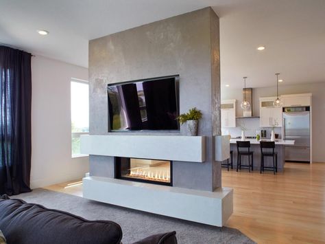 This fireplace surround was hand-faced by artisans at Granicrete. “The client wanted to see the trowel marks for a hand-crafted look,” says Granicrete’s Jean Eaton. Fireplace Facelift, Double Sided Fireplace, Concrete Fireplace, Interior Remodel, Contemporary Fireplace, Fireplace Remodel, Home Fireplace, Modern Fireplace, Cozy Fireplace