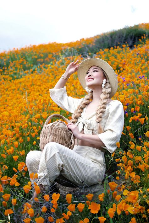 Happy spring! LA had the coldest and wettest winter I’ve experienced in years, but thanks to all the rain nature gifted us with a sea of blossoms all over Southern California! This year I got to enjoy the wildflower super bloom at  Walker Canyon Poppy Fields , where the mountains were gloriously ablaze in a blanket of orange blooms! #springoutfit #walkercanyonpoppyfields #superbloom #springfashion #ginghamfashion Sitting In A Flower Field, Woman In Field Of Flowers, Woman Surrounded By Flowers, Person Sitting In Flower Field, Happy Spring Day, Portraits In Flower Fields, Beautiful Eyes Images, Gingham Fashion, First Day Of Spring