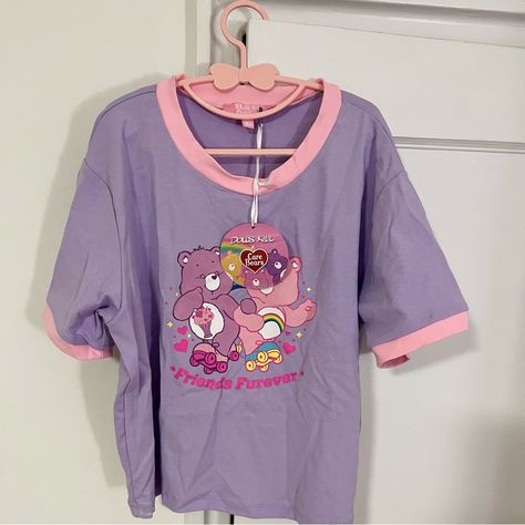 Nwt - Dolls Kill X Care Bears Best Of Buddies Purple/Pink Graphic Baby Tee - Xl Dolls Kill X Care Bears Best Of Buddies Graphic Baby Tee Because We're Gonna Be Friends Forever! This Lavender Baby Tee Features Short Sleeves, A Cropped Fit, Contrast Colored Pink Trim, And Cheer Bear & Share Bear Skating Together On The Front. Caption Says “Friends Furever”! Measurements: Chest - 38” Length - 18” Perfect For Spring! Carebear Outfits, Purple Harajuku Crew Neck Top, Fun Purple Crew Neck Top, Purple Cotton Kawaii Top, Purple Crew Neck Top With Cartoon Print, Playful Purple Tops With Cartoon Print, Purple Cartoon Print Tops For Spring, Purple Graphic Print Tops For Loungewear, Purple Harajuku Cotton Top