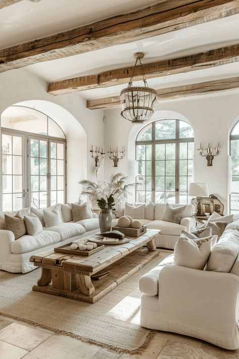 french farmhouse style living room with cream walls, cream sofa and cream bedding and rustic wood beams on the ceiling Farmhouse Living Room Ideas, Farmhouse Living Room Furniture, Farmhouse Living Room Decor Ideas, French Farmhouse Style, Farmhouse Style Living Room, Modern Farmhouse Living, French Farmhouse Decor, French Country Living Room, French Style Homes