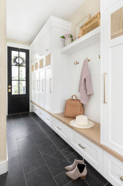 In an entryway to a remodeled Fruit Heights home, uniquely cut floor tile draws the eye through a mudroom furnished with a bench and seven built-in lockers, one for each family member. Caned locker screens and a dough-print wallpaper enhance the stylish utility space. Hallway Cupboards, Small Mudroom, Built In Lockers, Mudroom Cabinets, Utah Style, Mudroom Lockers, Mudroom Design, Laundry Mud Room, Built In Desk