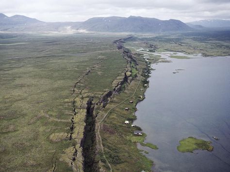 This rift valley in Iceland stretches along the Mid-Atlantic Ridge, where the North American and Eurasian tectonic plates are pulling apart from each other. The body of water to the right, Lake Thingvallavatn, is the largest lake in Iceland and was formed as a result of volcanic activity around the rift. The Thingvellir rift grows about 1 centimeter (.4 inch) every year. Seafloor Spreading, United Nations Environment Programme, Rift Valley, Plate Tectonics, Rio Grande, Geology, National Geographic, Fresh Water, Lake