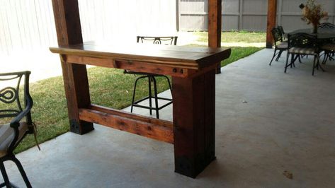 I love reinventing spaces to transform an existing area into something new. The pavilion I built in the backyard recently was a fabulous project, but it lacked one key component: a bar. That's when my wife had the idea to turn a section of the wooden deck railing into a bar top, complete with bar stools. Genius. Now we can enjoy an outdoor bar under my mini cooking pavilion. This bar top project was actually a bit more involved than I'd expected, and it required some special hardware, but once Bar Top Deck Railing, Pergola With Bar Counter, Post Mounted Patio Table, Narrow Outdoor Bar Table, Outdoor Bar Under Deck, Under Deck Bar Ideas, Deck With Bar Counter, Under Deck Bar, Pergola Bar Ideas