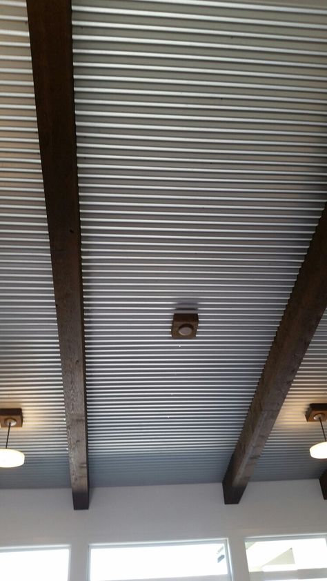 Corrugated tin ceiling with beams Painted Corrugated Metal Ceiling, Corrugated Metal Ceiling Basement, Metal Roof Interior Tin Ceilings, Corrugated Tin Ceiling Kitchen, Metal Ceiling Ideas Corrugated Sheets, Metal Porch Ceiling, Tin Ceiling Ideas Rustic, Tin Ceiling Ideas, Galvanized Tin Ceiling