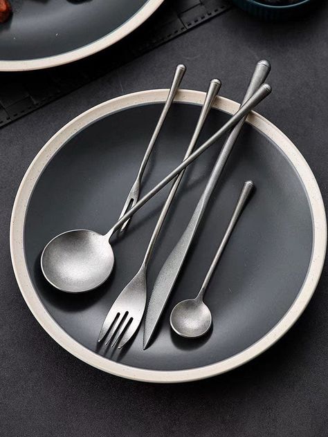 This Gohobi A Set of Pieces 5 Stonewashed Stainless Steel Cutlery is a luxurious addition to any kitchen. Crafted with a stunning stonewashed finish, this vintage-inspired stainless steel cutlery set is sure to elevate mealtime with its sophisticated and exclusive style. Give your kitchen a touch of sophistication and exclusivity with this cutlery set. This set of 5 stonewashed cutlery includes one of each: a spoon, fork, knife, teaspoon, and fruit fork. We aim to ship your order in reused/ recy Unique Silverware Sets, Restaurant Cutlery, Minimalist Kitchen Essentials, High Key Photography, Cookware Set Best, Luxury Cutlery, Starting A Restaurant, Spoon Fork Knife, Ceramic Cutlery