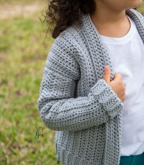 Even beginners can crochet this simple children's cardigan! Learn how to crochet a sweater for kids with this free pattern & video tutorial. #crochetcardigan #crochetforkids #crochetsweater #freecrochetpattern Kids Cardigan Crochet, Crochet Baby Cardigan Free Pattern, Kids Sweater Pattern, Crochet Cardigan Pattern Free, Yarn Patterns, Kids Cardigans, Crochet Sweater Pattern Free, Crochet Baby Cardigan, Crochet Toddler