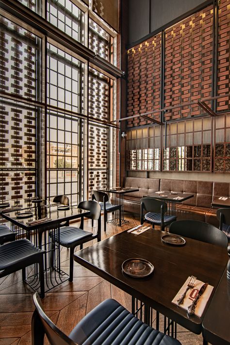 Monochromatic Restaurant, Double Height Restaurant, Double Height Restaurant Interior Design, Restaurants With High Ceilings, Cafe With Mezzanine, Mezzanine Floor Restaurant Design, Mezzanine Restaurant, Restaurant With Mezzanine Floor, Industrial Restaurant Interior