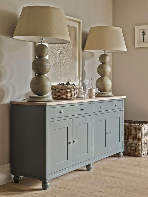 Cottage dining room features walls painted taupe lined with a gray sideboard cabinet topped with butcher block and stacked sphere lamps atop a pine floor. Cabinet With Butcher Block Top, Dining Room Feature Wall, Vstupná Hala, Cottage Dining Rooms, Dining Room Cabinet, Butcher Block Top, Grey Interior Design, Sideboard Grey, Diy Furniture Renovation