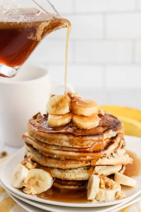 Banana Pancakes stacked on white plates with syrup pouring over top Easy Banana Pancake Recipe, Celebrating Sweets, Easy Banana Pancakes, Banana Bundt Cake, Banana Bundt, Blueberry Banana Bread, Pancake Calories, Banana Pancakes Recipe, Brown Sugar Glaze