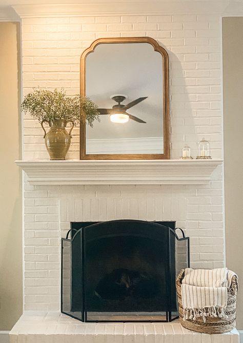 White Brick Fireplace With White Mantle, Cream Brick Fireplace, White Brick Fireplace Christmas Decor, Cream Painted Brick Fireplace, Two Story White Brick Fireplace, Tall White Brick Fireplace, Brick Fireplace With Mantle, White Mantel Mirror, Brick Fireplace Mantle Decor