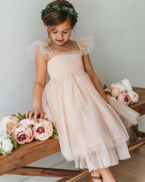 A flutter sleeve, smocked bodice and layered soft tulle make this piece a standout. For photos and all the events, the soft peachy pink color is a beautiful hue that is timeless. Sleeves are flexible and can be worn on or off the shoulder, according to preference. Sizing: Sizing is true to size and flexible. Lengths be Little Bridesmaids Dresses Kids, Toddler Pink Dress, Kids Tulle Dress, Weasley Burrow, Pastel Summer Wedding, Flower Girl Dresses Pink, Pink Toddler Dress, Juliet Dress, Fairy Garden Birthday