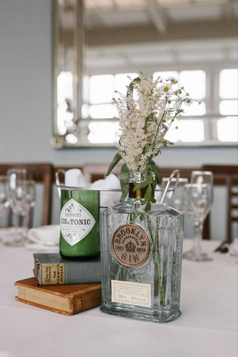 Alcohol Wedding Centerpieces, Whiskey Bottle Vase, Flowers In Whiskey Bottles, Rum Bottle Centrepiece, Decanter Wedding Centerpiece, Liquor Bottle Vase, Liquor Bottle Wedding Decor, Whisky Bottle Centerpiece Wedding, Whiskey Bottle Wedding Centerpieces