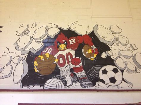 I painted this Cardinal mascot mural in the gym at my school! Sports Murals School, Wall Graphics Design, High School Mascots, Office Wall Design, School Wall Art, Creative Wall Decor, Cartoon Artwork, Murals For Kids, School Murals