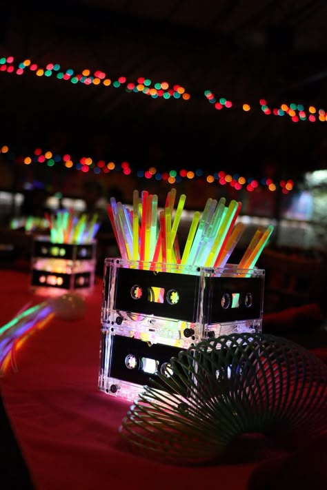 80s centerpieces. Glow sticks and cassette tApes Disco Theme Parties Decorations, Disco Theme Parties, 90s Party Ideas, Decades Party, 70s Party Theme, Disco Theme Party, 80s Party Decorations, 80s Birthday Parties, 1980s Party