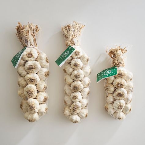 Find farm fresh garlic braids here at McFadden Farm. Generously sized garlic bulbs are beautifully weaved together to create a stunning culinary treat. Pluck garlic bulbs as needed for delicious recipes while decorating your kitchen or dining room. Our extra long garlic braids are gorgeous tabletop while our shorter garlic braids and swags hang nicely in the kitchen or on a door. Fresh garlic braids make the perfect summer grill mate and fall and winter holiday gifts. Garlic Braid Decor, Garlic Braid, Garlic Twist, Summer Grill, Garlic Bulbs, Decorating Your Kitchen, Honey Gifts, Garlic Bulb, Culinary Herbs