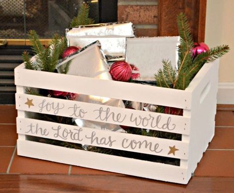 Blogger Amy wanted to surprise her son with little gifts that would segue into their daily activities. To separate these "advent gifts" from the rest of his Christmas presents, she used a wooden crate dressed up with paint and a festive quote to hold them. For an extra touch of holiday embellishment, Amy added ornaments and pine bough bedding to her crate.