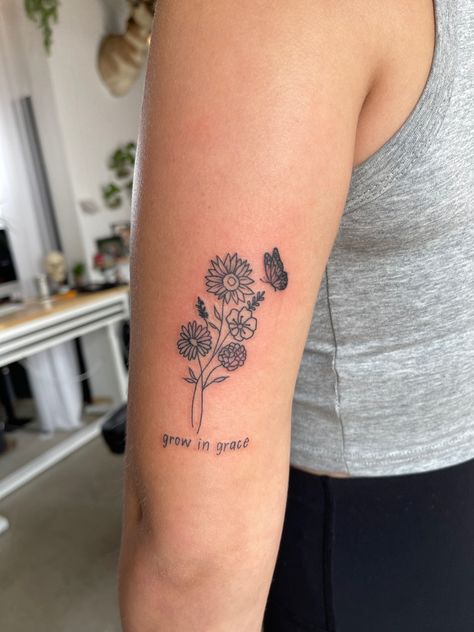 Back Of Arm Tattoo Meaningful, Flower Tattoos Behind Elbow, Simple Flower Tattoo Back Of Arm, Tattoo Ideas Female Above Elbow, Good Places To Get Flower Tattoos, Bloom And Grow Tattoo, Grandma Flower Tattoo, Grace Flower Tattoo, Flower Bouquet Tattoo With Words