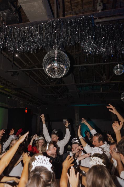 nye-wedding-new-years-eve-wedding-december-the-record-bentonville-arkansas-bride-wedding-dress-bride-kansas-city-KC-black-tux-groom-long-veil-pearl-earrings-big-white-bouquet-classic-classy-timeless-bride-and-groom-poses-pose-disco-ball-checker-dance-floor-black-white-silver-reception-kiss-at-midnight-direct-flash Black And White Disco Ball, Checkered Dance Floor, Wedding December, Veil Pearl, Timeless Bride, Serenity Garden, New Years Eve Wedding, Bentonville Arkansas, Nye Wedding